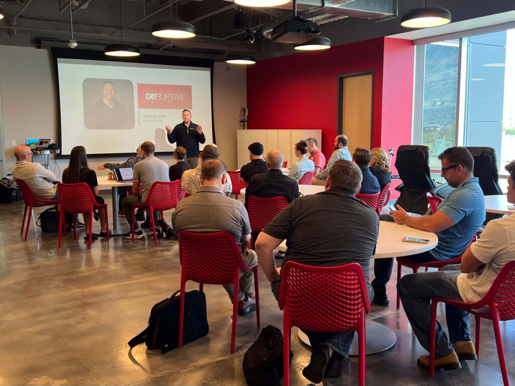 Chad de Lisle, VP of Marketing at Disruptive, speaks to Utah Marketing Group attendees during a presentation.
