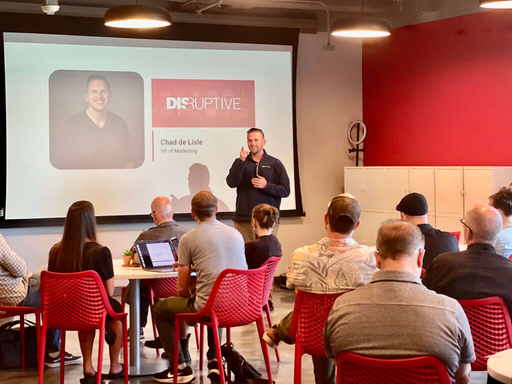 Chad de Lisle, VP of Marketing at Disruptive, speaks to Utah Marketing Group attendees during a presentation.