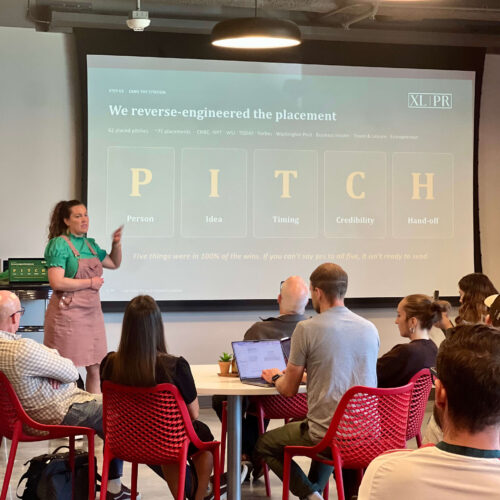 Utah Marketing Group attendees listen to a presentation on PR pitching, with a speaker explaining a five-part media pitch checklist.