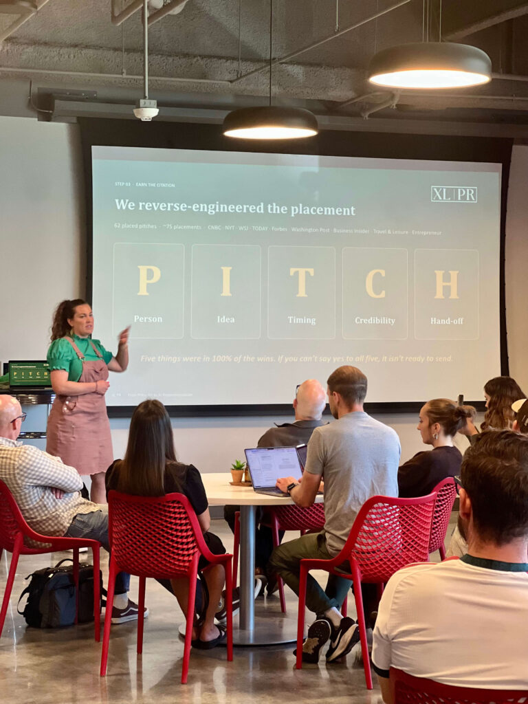 Utah Marketing Group attendees listen to a presentation on PR pitching, with a speaker explaining a five-part media pitch checklist.