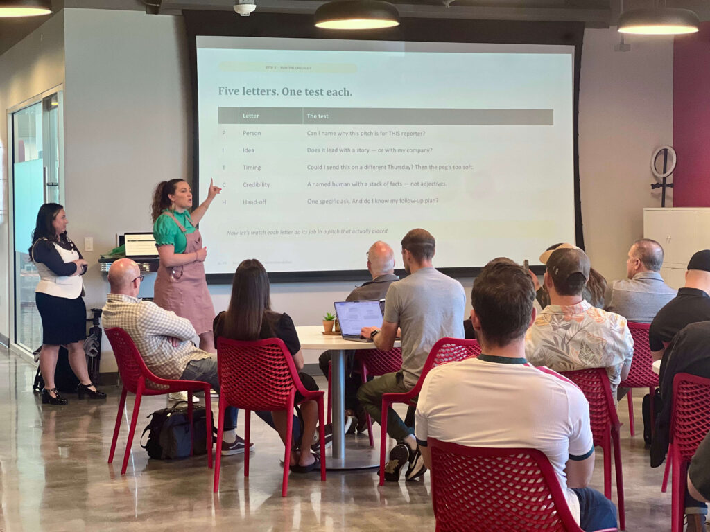 Utah Marketing Group attendees listen to a presentation on PR pitching, with a speaker explaining a five-part media pitch checklist.