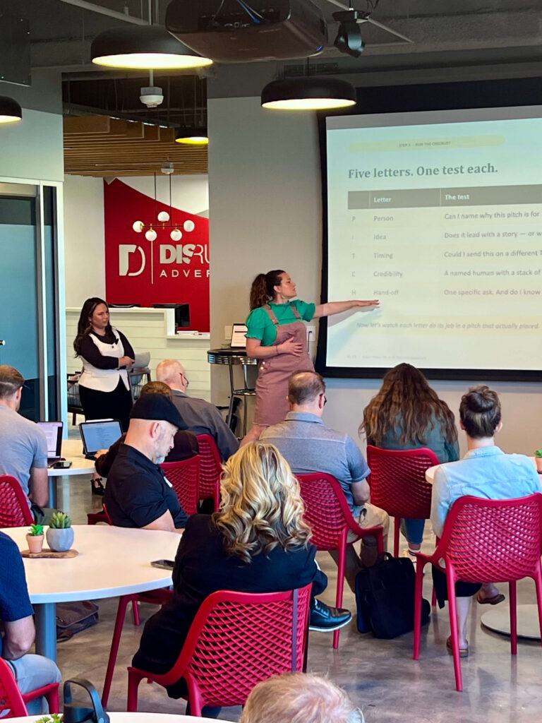 Utah Marketing Group attendees listen to a presentation on PR pitching, with a speaker explaining a five-part media pitch checklist.